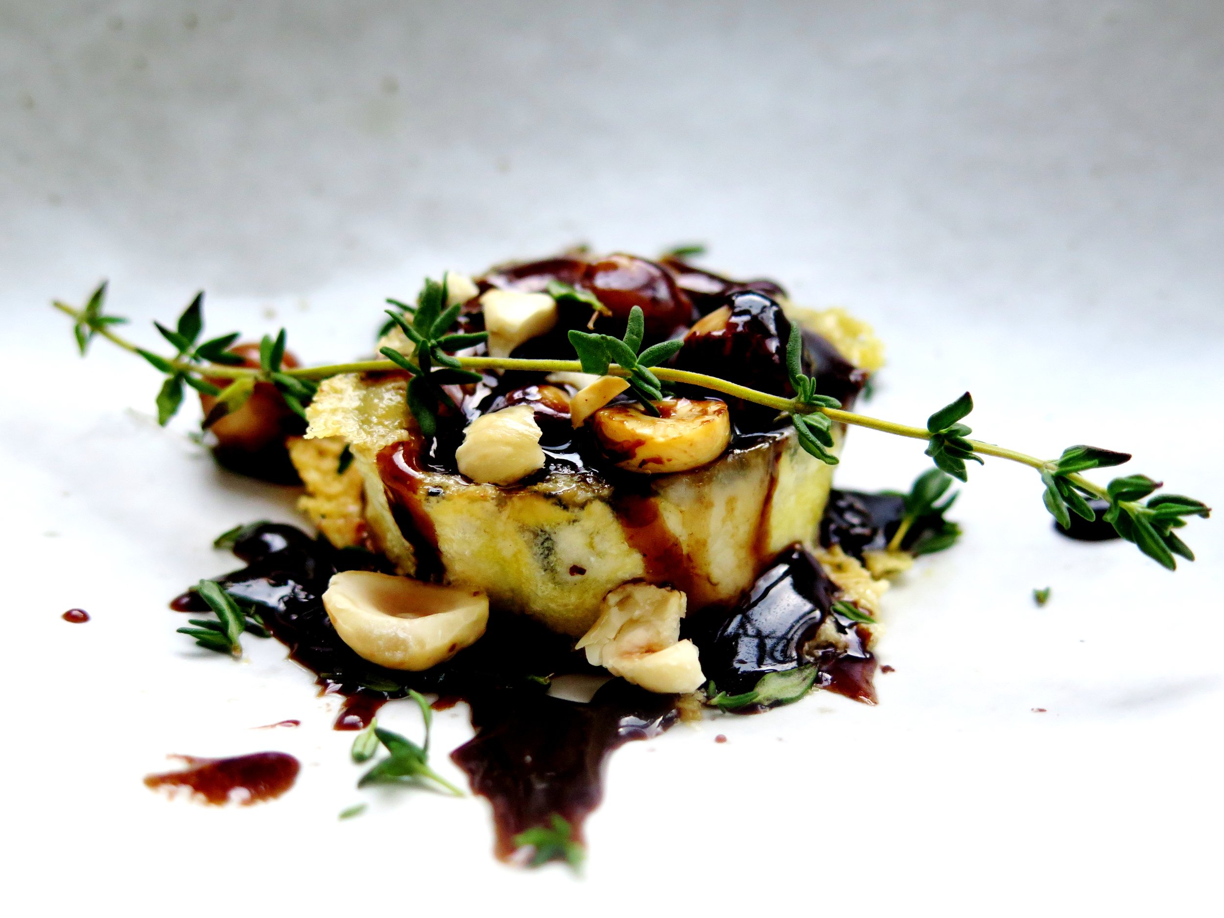 Crispy molten goat’s cheese with caramelised, thyme-infused maple balsamic and toasted hazelnuts