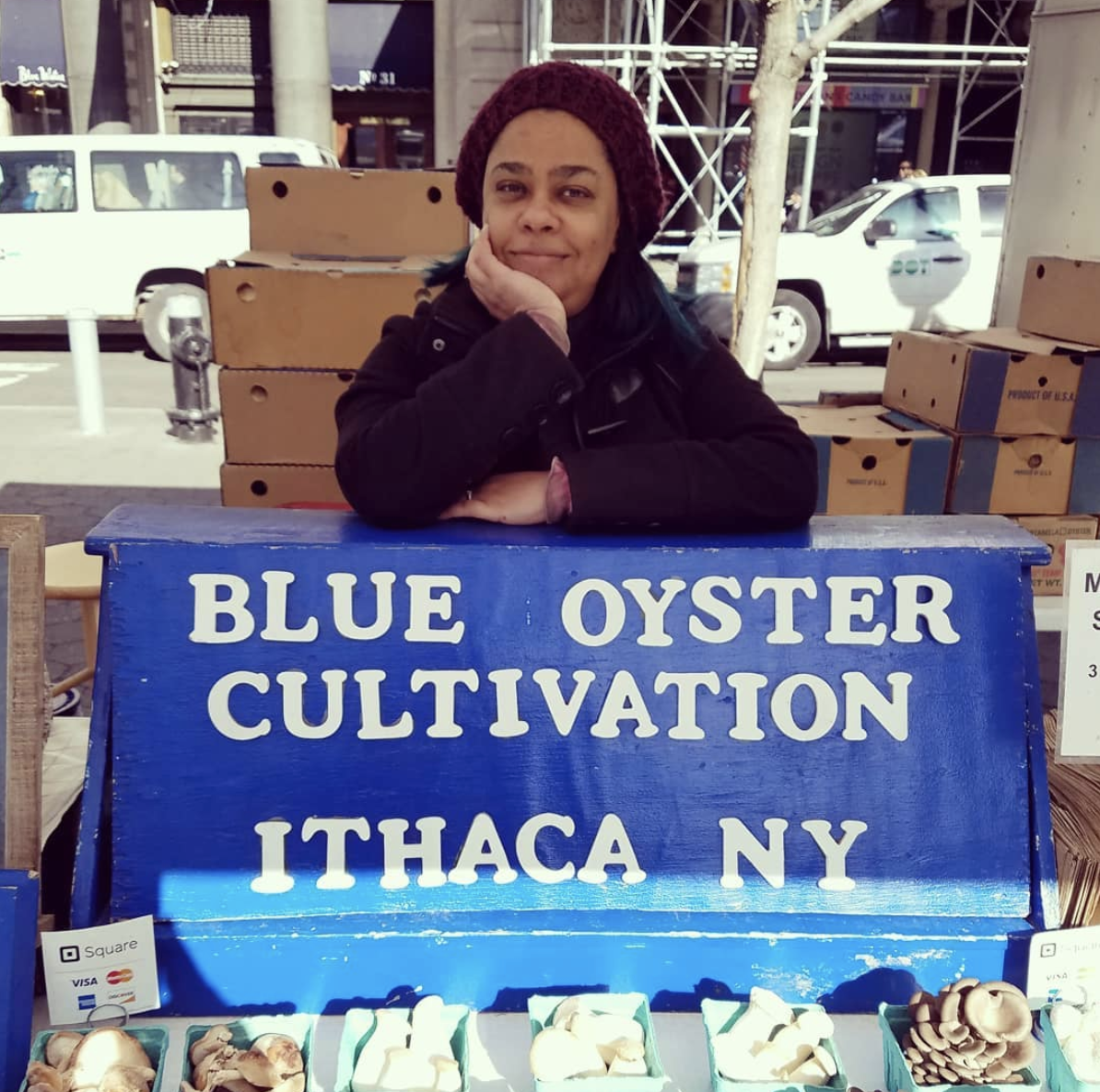 Blue Oyster Club owner in front of booth