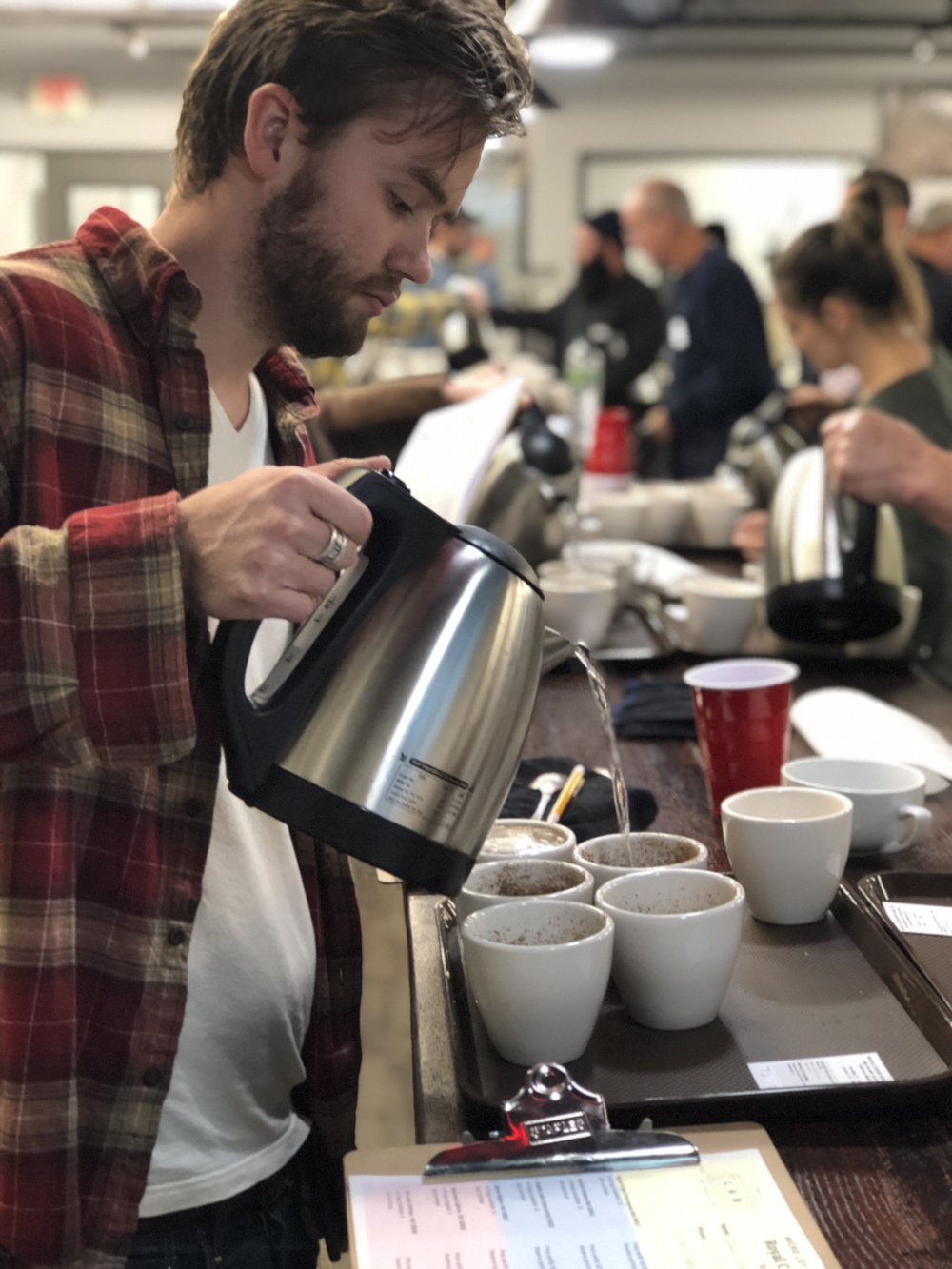 Water being poured during a Colombian micro lot specialty coffee cupping event at The Lab by Royal New York