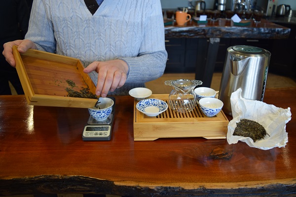 puer tea being weighed on a scale before it is  brewed gongfu style