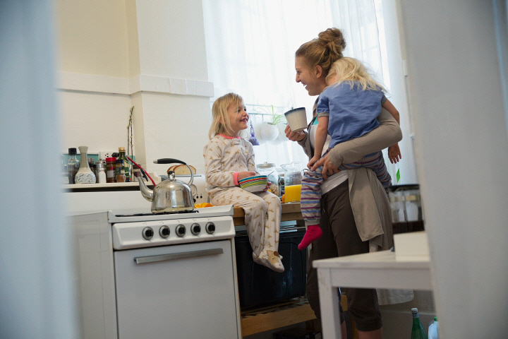 Mother and daughters in morning kitchen