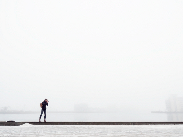 Sweden Skane Malmo Man taking photo on pier