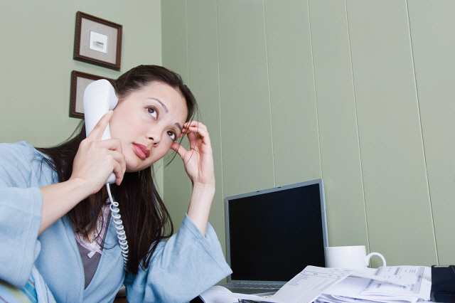 Stressed woman talking on telephone