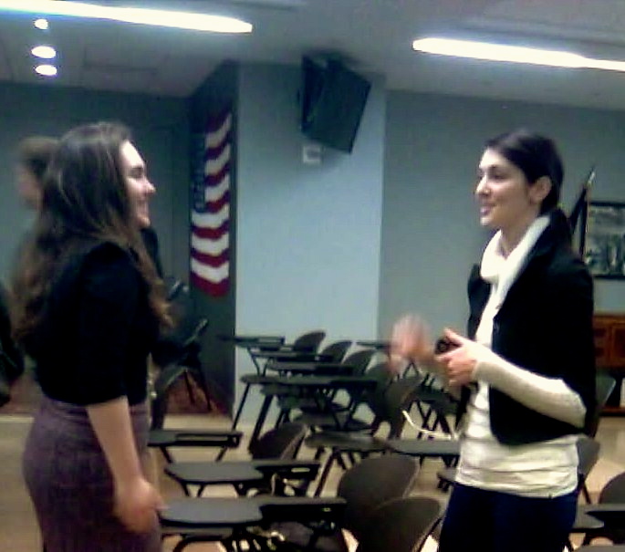 Catherine Ratcliffe ('14) and Carly Calhoun ('15) talk after the noon meeting