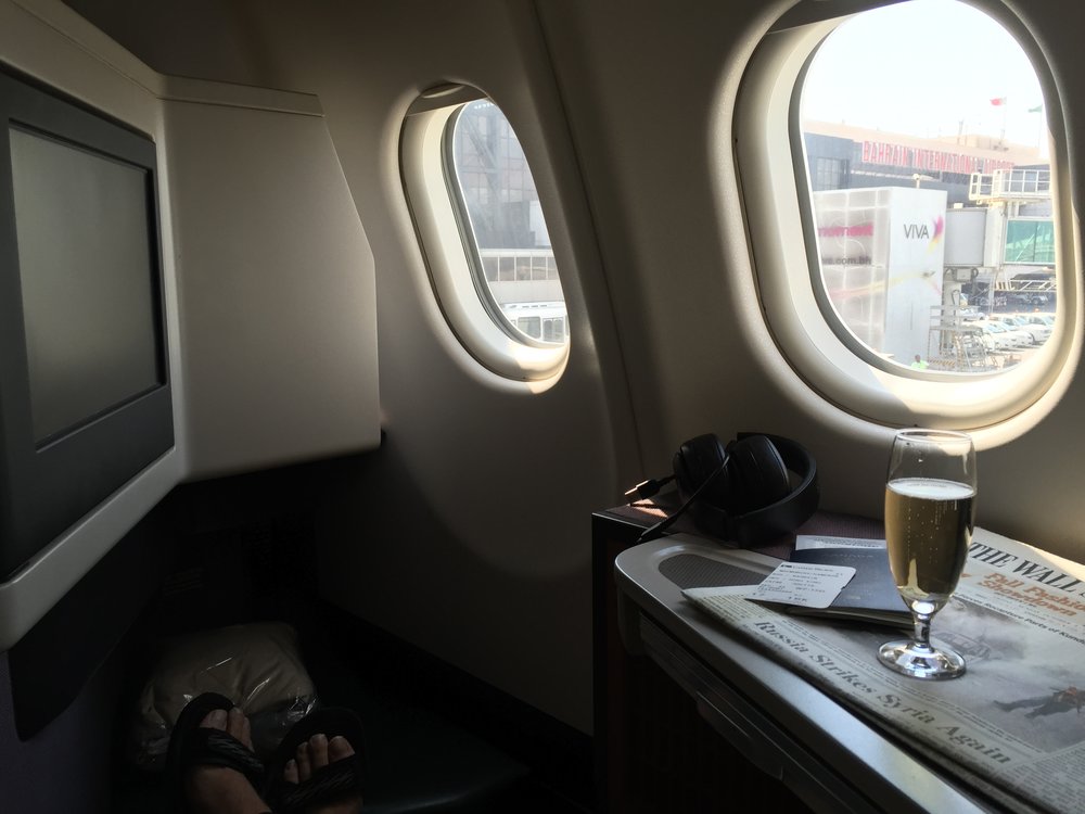  An aperitif prior to push back on board CX746 from BAH --></noscript> HKG. “> An aperitif prior to push back on board CX746 from BAH –> HKG.</p>
<p><strong>#5nights5cities</strong></p>
<p>My upcoming whirlwind trip is mostly based on points. I am using Asia Miles to book business class on Qatar Airways from Hong Kong to Warsaw with an overnight layover in Doha. I have flown Qatar twice before, on a round-trip to Munich in 2012, and I can’t wait to sample the hospitality on board the <a href=