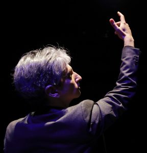 A revelatory moment as Hershey Felder playing Leonard Bernstein demonstrates Dimitri Mitropoulos’s conducting style. Top: Felder, a virtuoso pianist, plays a nine- foot Steinway center stage as Bernstein.