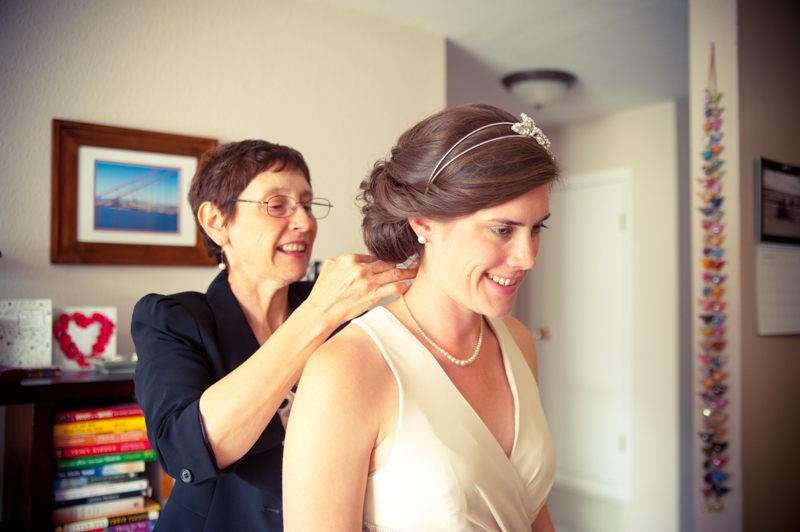 Mother of bride helping with jewelry