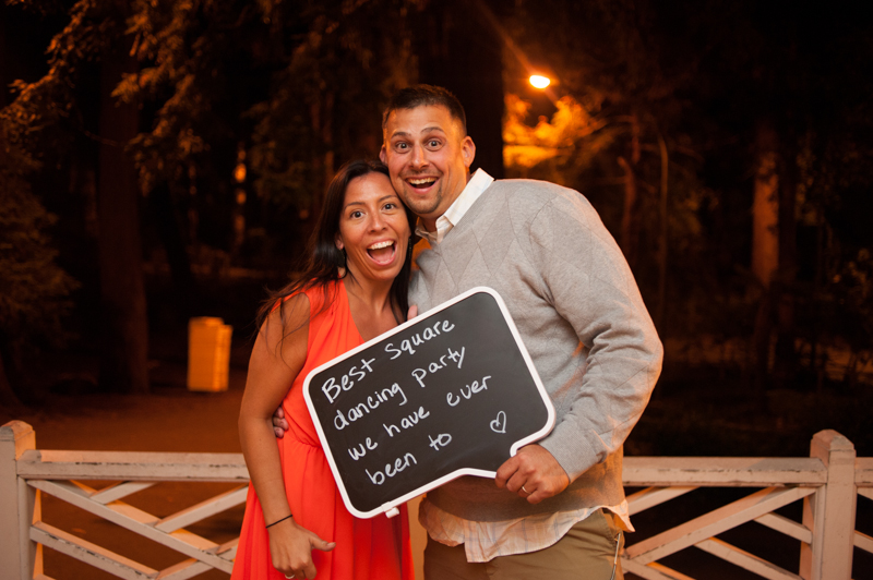 Wedding guests holding message to couple