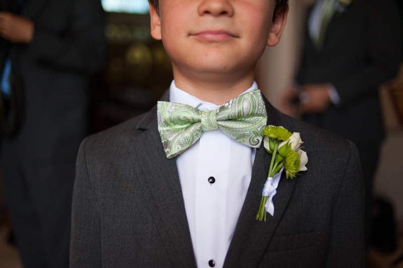 Detail of ring bearer wearing bowtie and boutonniere