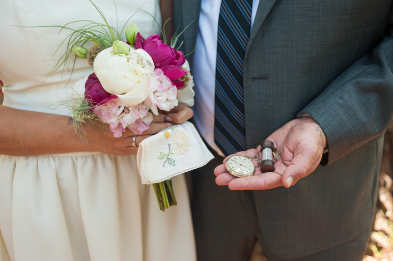Detail of bride and groom holding family heirlooms