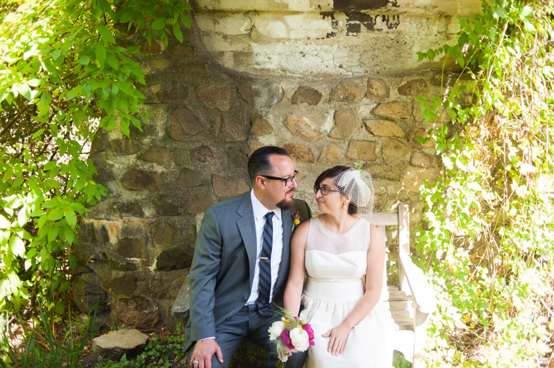Bride and Groom under stone bridge in Tilden Botanic Garden