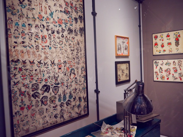  Tony D'Annessa's tattoo shop with original window shade flash used in the 1960's. Made to easily roll up if the police came looking for tattooists. In 1961, it became illegal in New York to be a tattooist. 
