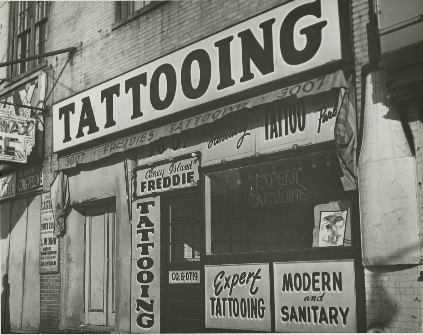  Irving Herzberg, “Tattoo shop of ‘Coney Island Freddie’ just prior to New York City’s ban on tattooing” (1961), digital print (courtesy Brooklyn Public Library)    