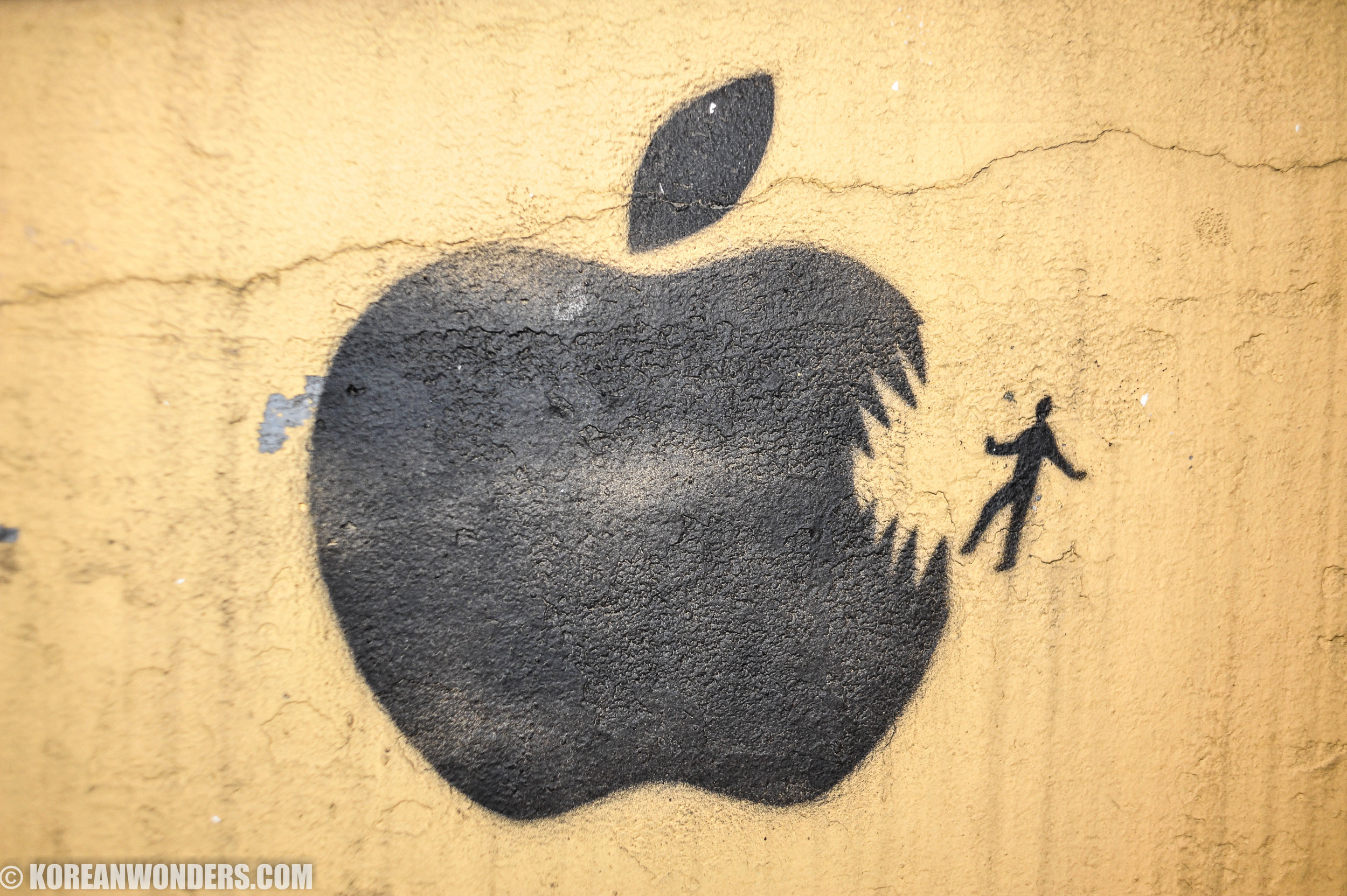 Apple eating man graffiti