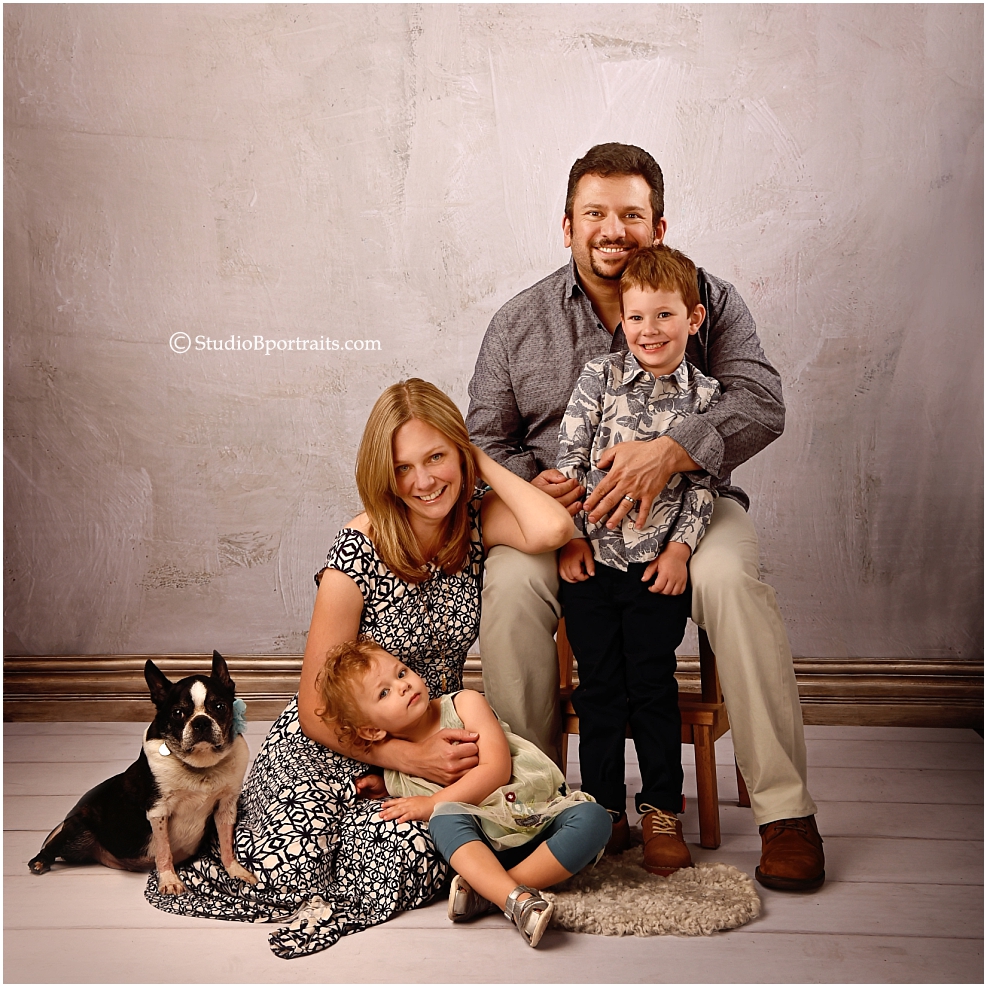 Modern family portrait in the studio with puppy boston terrier dog