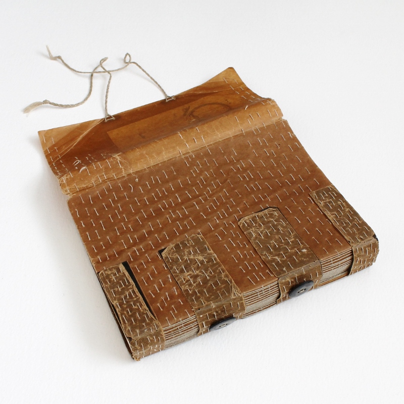 embroidered wax paper crossed structure binding after 14 months in use - handmade by Kaija Rantakari / paperiaarre.com