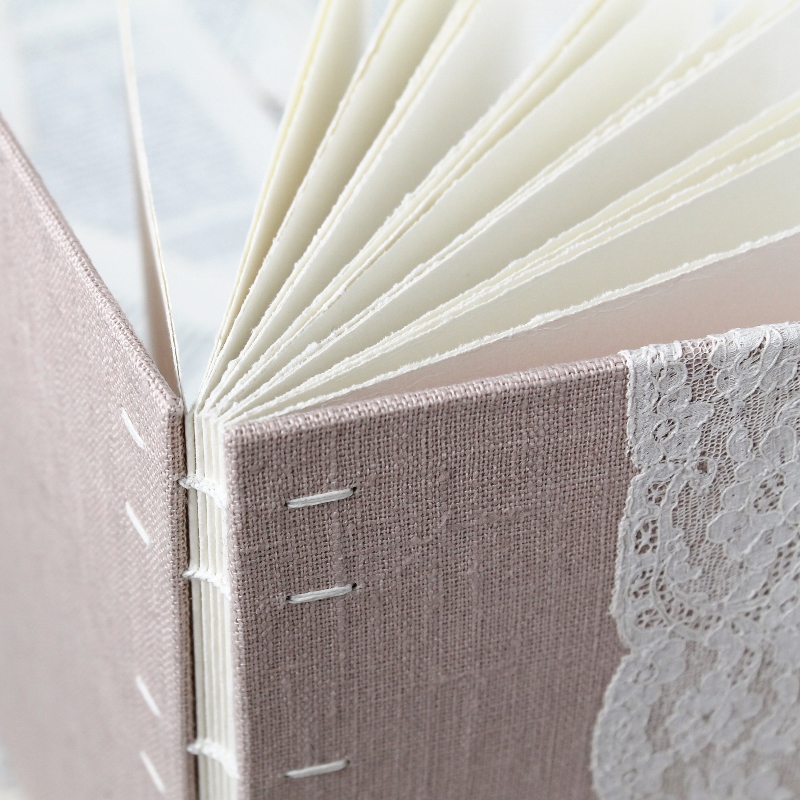 Coptic bound guestbook with blush pink linen and floral vintage lace - handmade by Kaija Rantakari / www.paperiaarre.com