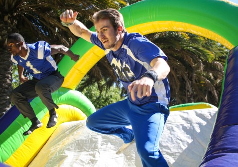 Students race through the bouncy house during club row on Thursday at Santa Monica College. Participants were greeted with refreshments after competing.