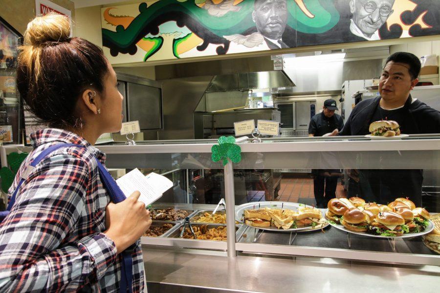 Brenda De Angel asks about options at Eat Street using her 5 dollar voucher from the FLVR program on SMC campus in Santa Monica Calif. on March 15, 2016.