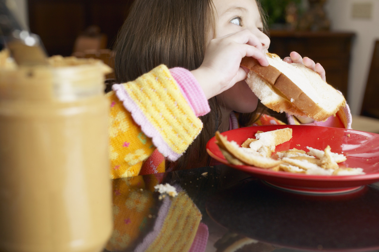 Girl Eating Peanut Butter Sandwich