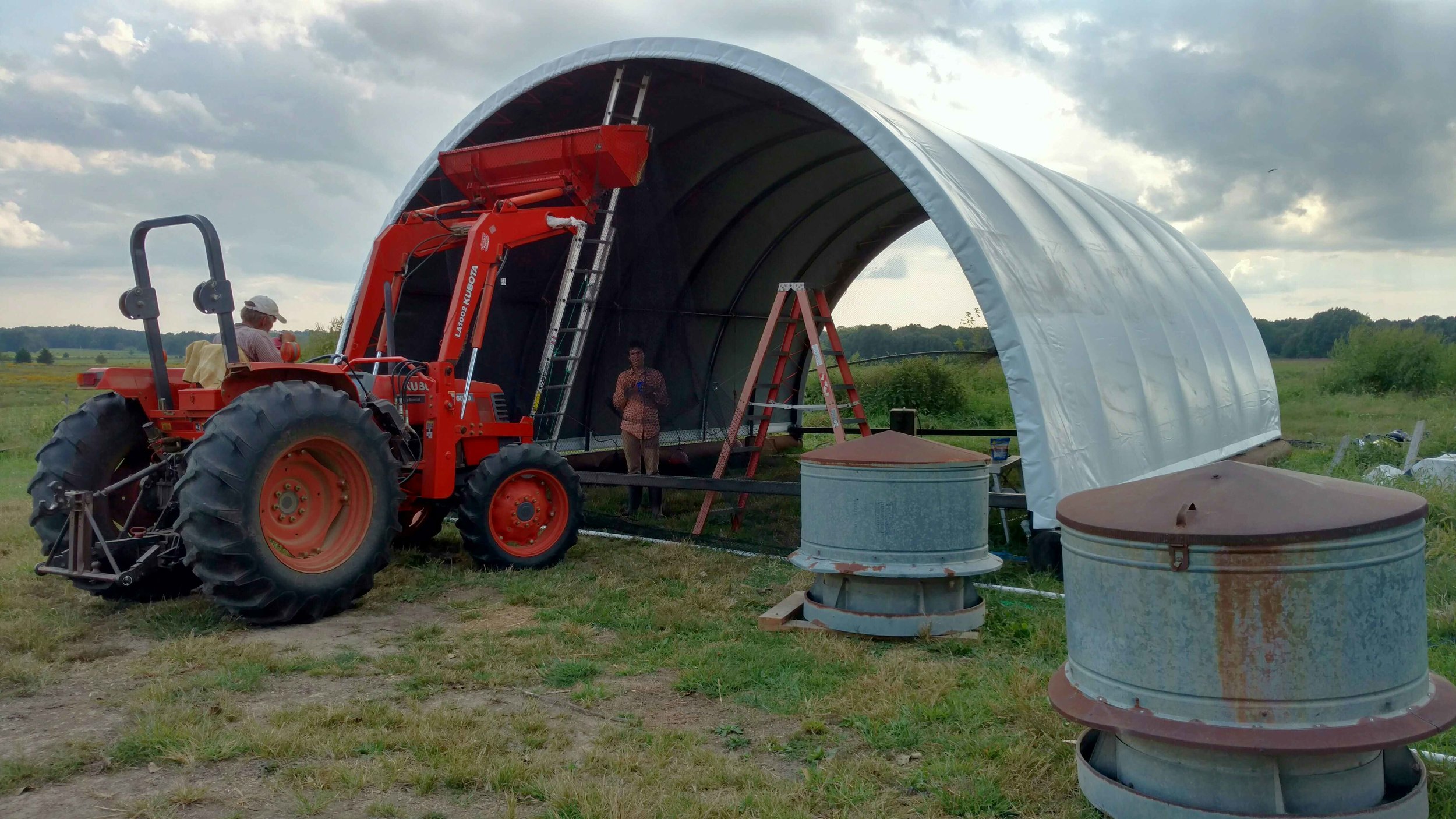 Final touches on hoop house.