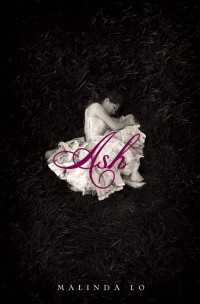 The book cover for ASH by Malinda Lo, published by Little, Brown Books for Young Readers, showing a girl in a white dress lying curled up on the grassy ground
