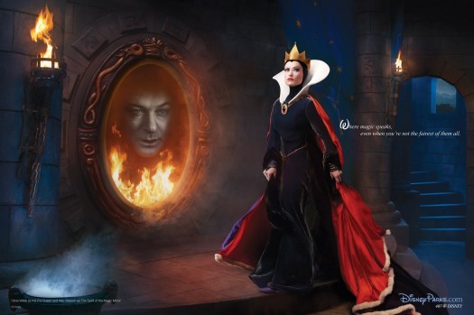 The image, an ad for Disney's theme parks, shows actress Olivia Wilde as the evil queen in Disney's "Snow White" and Alec Baldwin as the mirror
