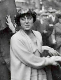 Photograph of Minnie Lansbury cheered by grounds, on her way to prison in 1921
