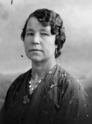 A lady with waved hair and a floral print dress