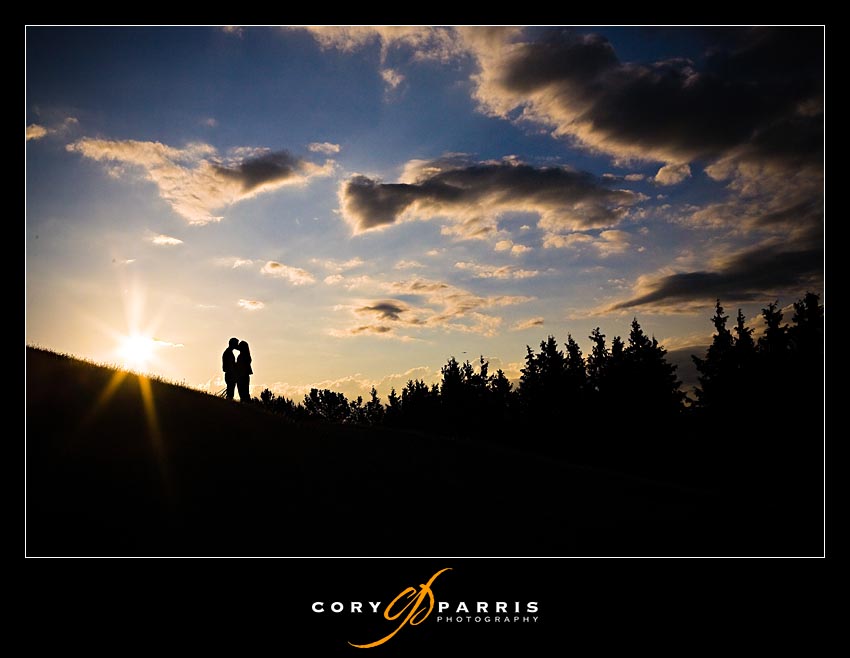 sunset photo of couple on the hill with clouds
