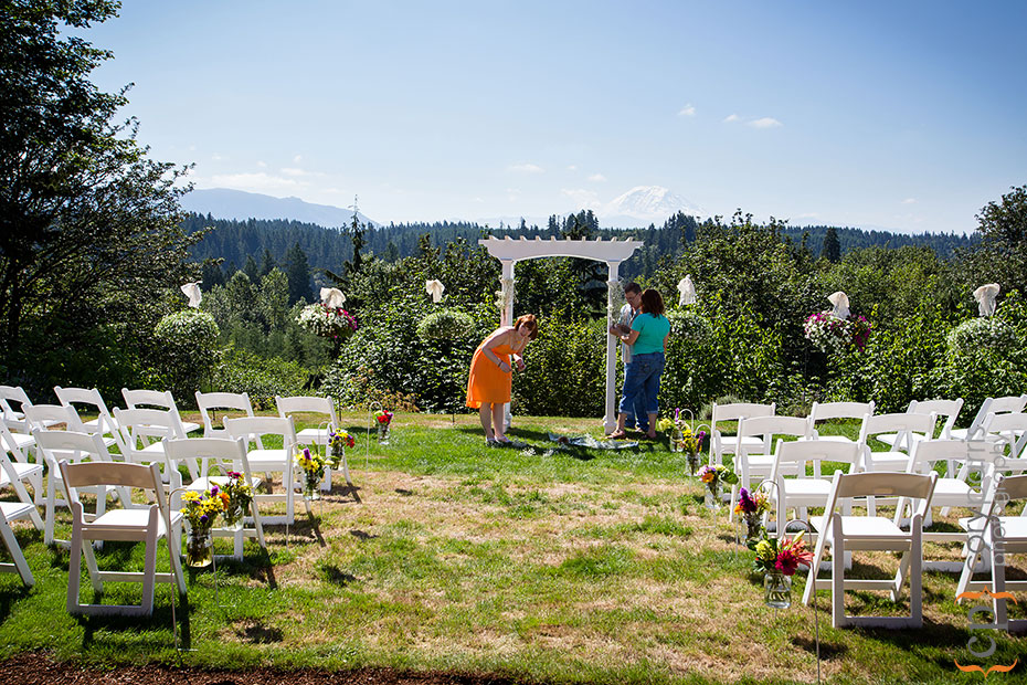 Setting up for a backyard wedding in front of Mt. Ranier