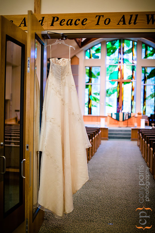 wedding dress hanging in the church vestibule