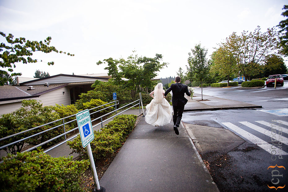 bridal couple running from the rain