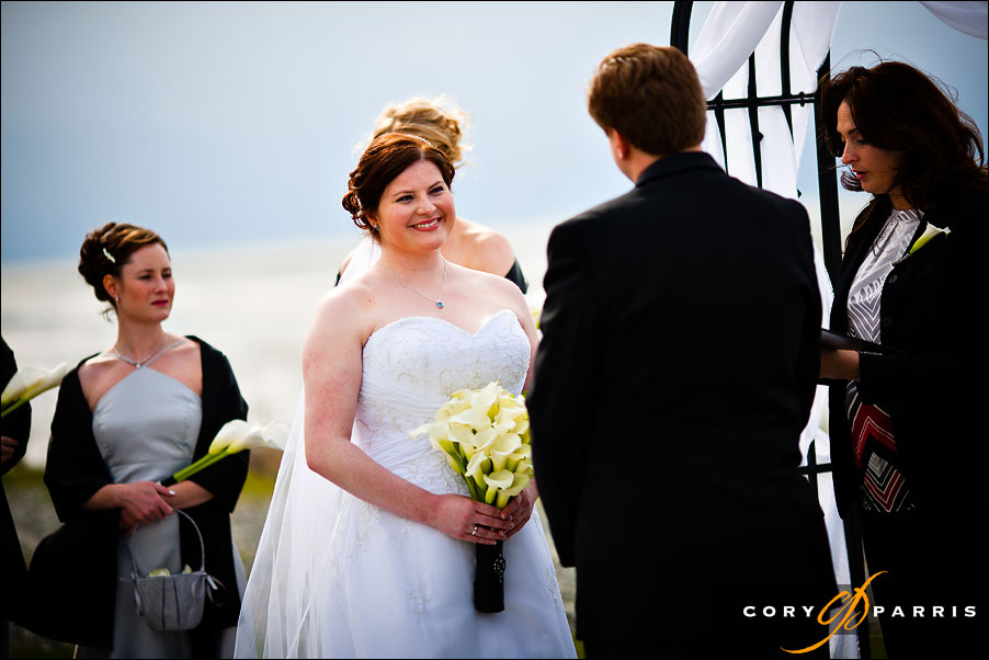 bride smiling at groom during the wedding ceremony by seattle wedding photographer cory parris