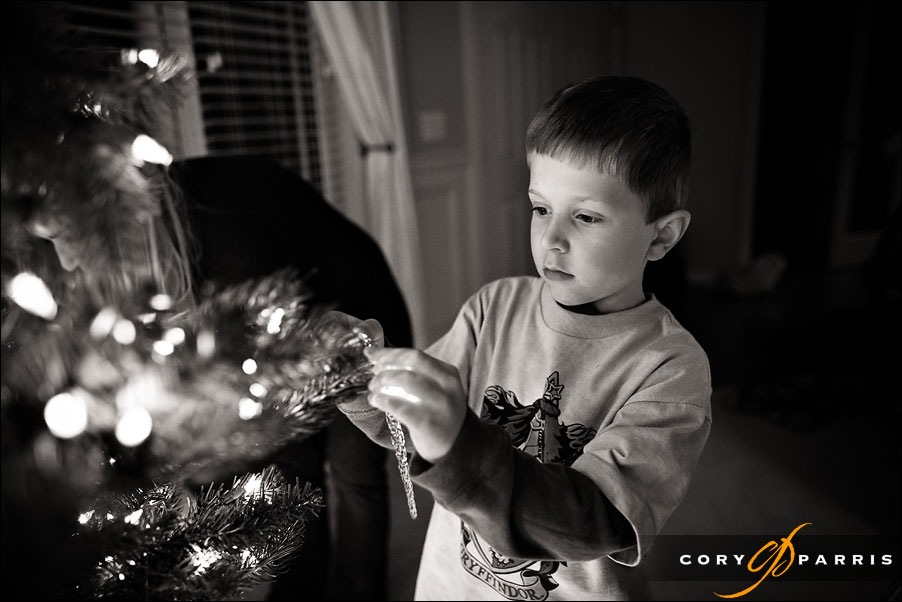 Cute little boy decorating a chrstmas tree by seattle wedding photographer cory parris