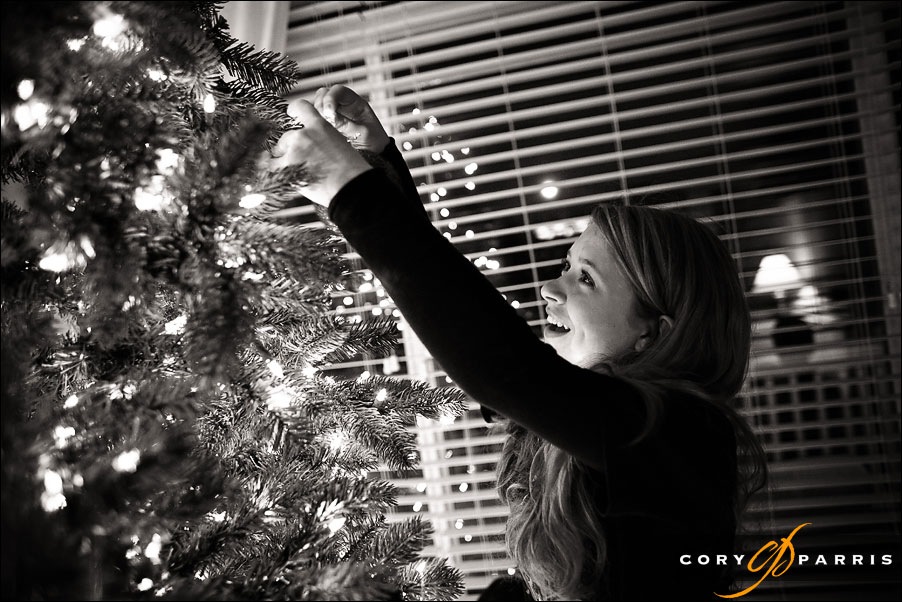 teenage girl decorating a christmas tree by seattle wedding photojournalist cory parris