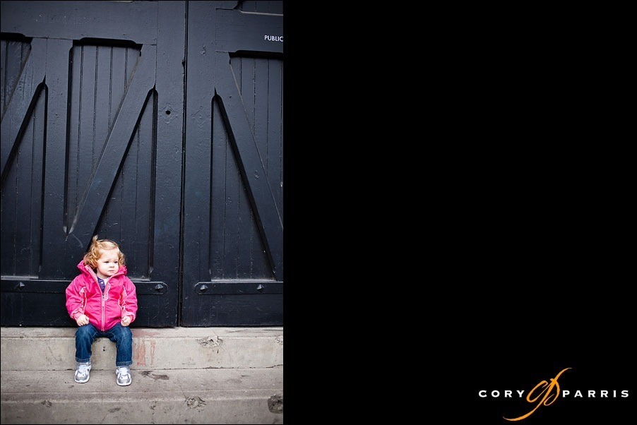 toddler girl with a big black door by seattle wedding photographer cory parris