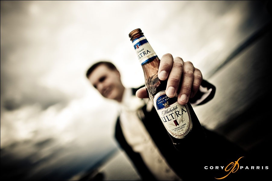groom and beer at woodmark hotel by seattle wedding photographer cory parris