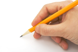 writing with pencil isolated against white background