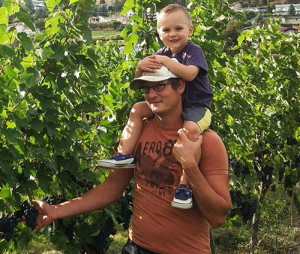 Vineyard manager Scott Ingram, with a little "help", reviews grapes destined for Perseus wines.