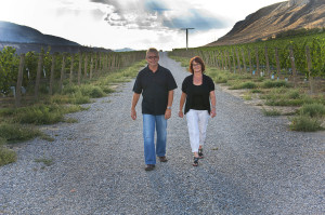 Harper's Trail owners Ed and Vicki Collett walk through their Thadd Springs vineyard in Kamloops  (photo by Linda Williams) 