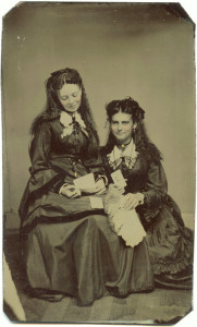 ca. 1870-80’s, [tintype portrait of two women admiring cabinet cards and carte de visites] via Ebay