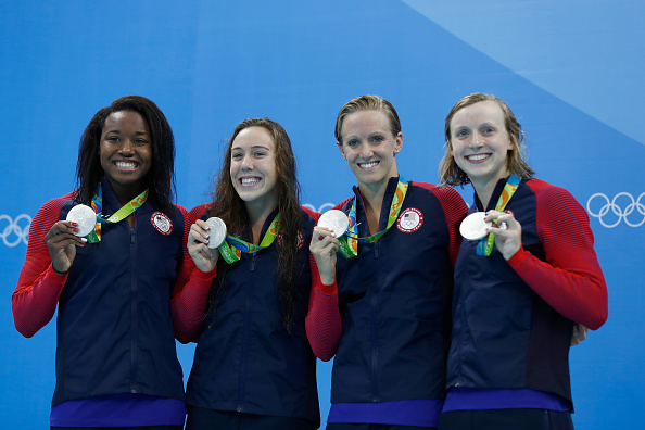 Katie Ledecky, right, with, from left, Simone Manuel, Abbey Weitzeil, Dana Vollmer after Sunday's women's 4x100 freestyle relay // Getty Images 