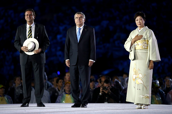 IOC president Thomas Bach, center, with Rio mayor Eduardo Paes and Tokyo governor Yuriko Koike at the Aug. 21 Olympic closing ceremony // Getty Images 