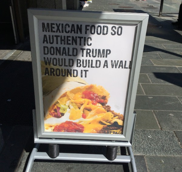 Photo of a sign outside a restaurant in Norway that reads "Mexican food so authentic Donald Trump would build a wall around it"