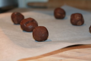 Frozen chocolate cookie dough balls on a baking tray