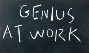 genius at work title written with chalk on blackboard