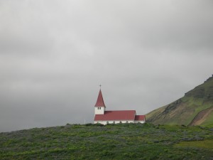 solitary church on hillside above Vik