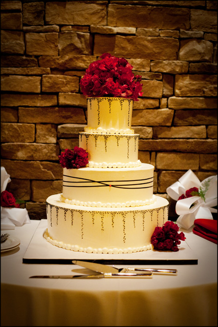 Beautiful wedding cake with red and black accents 