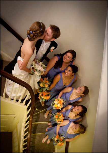 Photograph of the bridal party looking up at the bride and groom kissing at the Presbyterian Church of Chestnut Hill